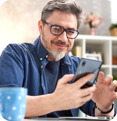 bearded man smiling at phone