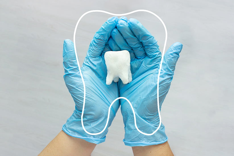 giant tooth in dentist hand